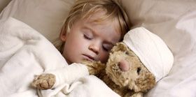 boy and teddybear in bed
